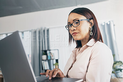 Buy stock photo Laptop, typing and business woman in home living room for startup research, networking and creative freelancer online. Serious designer on computer, reading email and communication for remote work