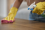 Woman, cleaning and table with gloves, spray and closeup by maintenance, housekeeping and detergent for bacteria. Person, cloth and fresh for service, cleaner and home by chemical, furniture and dust