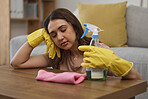 Tired maid woman, floor and home by table with cloth, gloves or bottle for detergent spray for spring cleaning. Burnout, fatigue and cleaner with soap in house for sleeping, rest or exhausted at desk