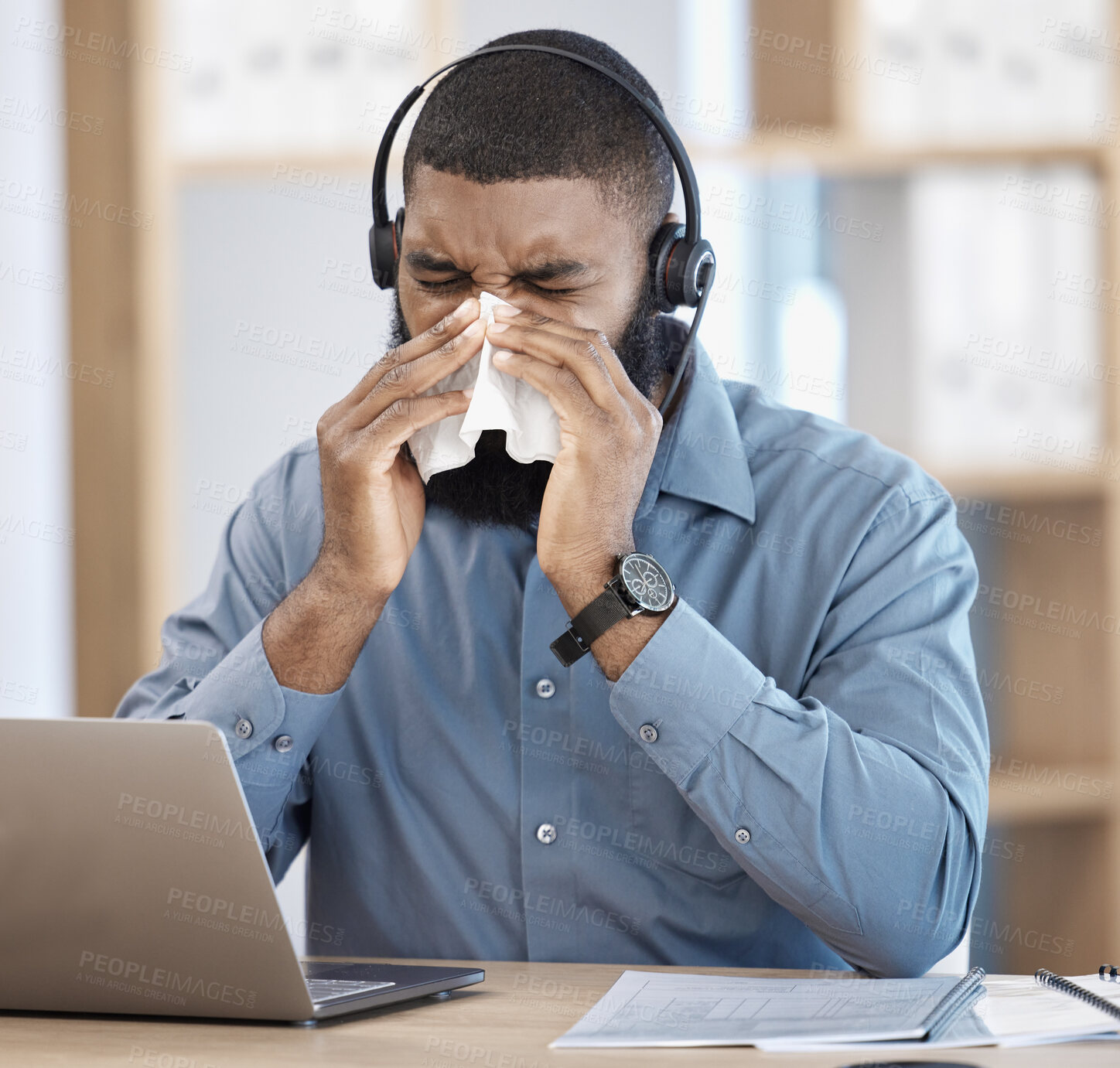 Buy stock photo Black man, sick and call center blowing nose with tissue, allergy or flu in customer service at office. African male person, consultant or agent with cold, symptoms or immune virus at workplace