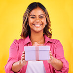 Happy woman, portrait and gift box for present, birthday or event against a yellow studio background. Female person smile giving prize, giveaway or celebration for surprise, package or ribbon parcel