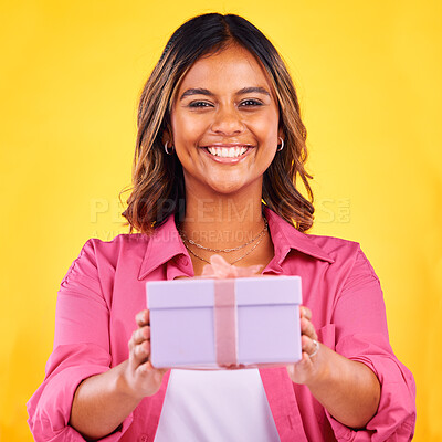 Buy stock photo Happy woman, portrait and gift box for present, birthday or event against a yellow studio background. Female person smile giving prize, giveaway or celebration for surprise, package or ribbon parcel