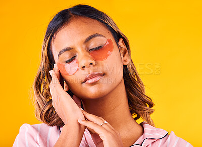 Buy stock photo Woman, eye mask and beauty with skincare, dermatology and cosmetic product on yellow background. Peace, calm and self care treatment with patch, facial for antiaging with glow and wellness in studio