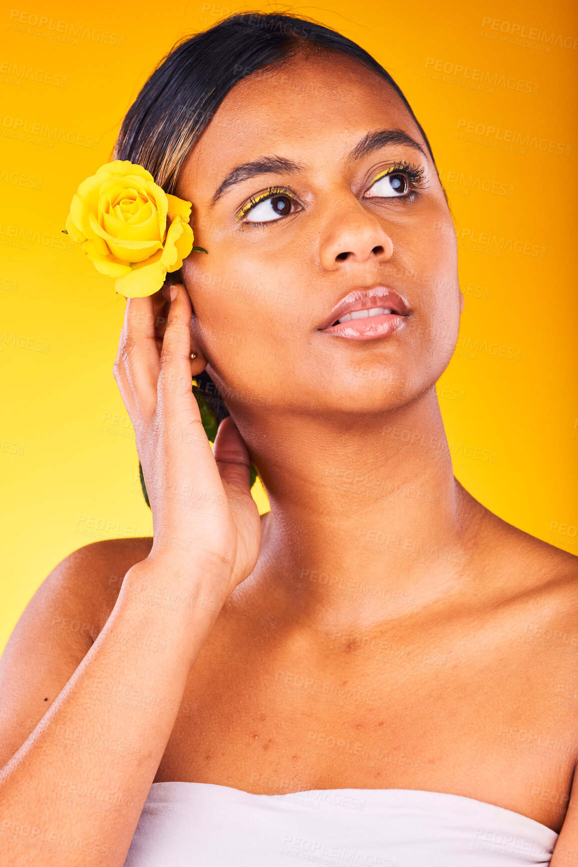Buy stock photo Skincare, flower and young woman in studio with cosmetic, glow and beauty face routine. Dermatology, floral rose and female model from Mexico with facial skin treatment isolated by yellow background.