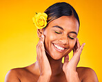 Cosmetic, flower and young woman in studio with beauty, glow and skincare face routine. Makeup, rose and female model from Mexico with facial dermatology treatment isolated by yellow background.