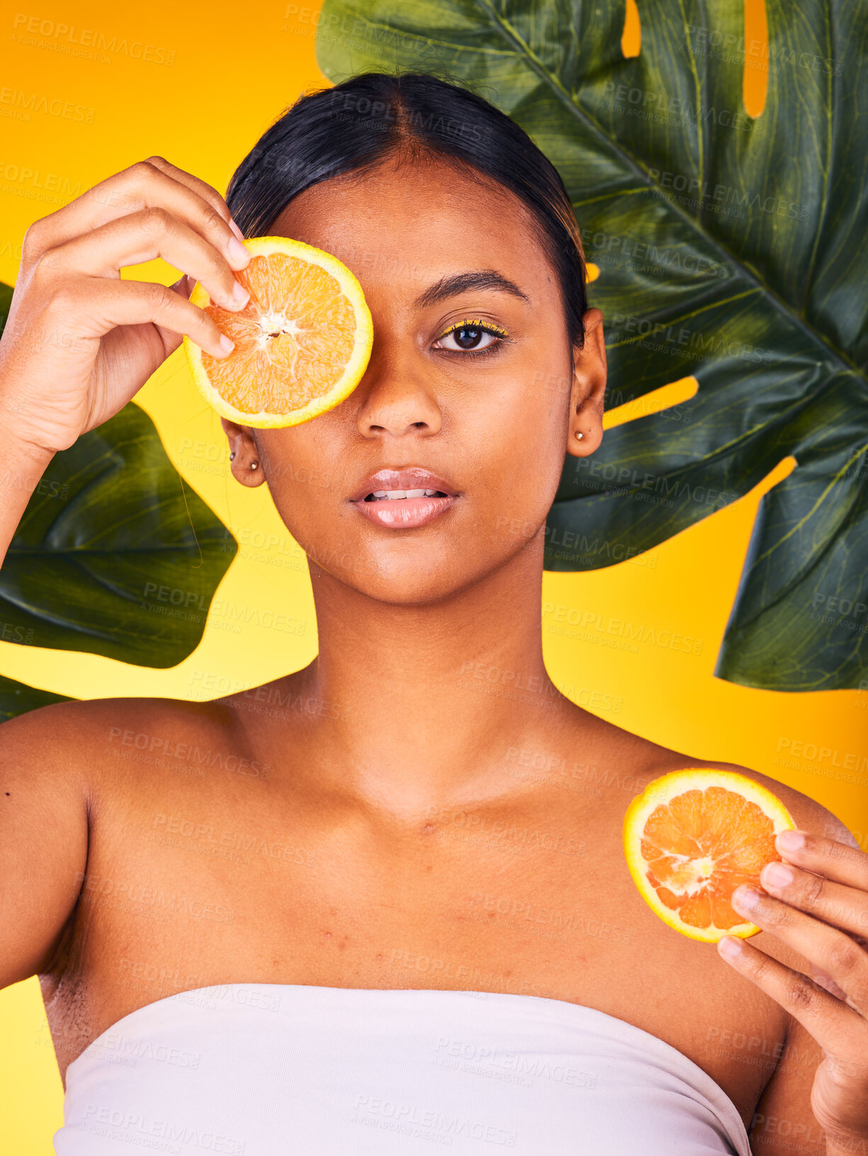 Buy stock photo Woman, portrait and orange in beauty for vitamin C, skincare or detox with leaves against a studio background. Female person or model with natural organic citrus fruit or food for healthy nutrition