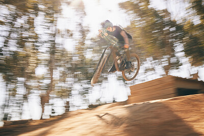 Buy stock photo Motion blur, mountain bike and cycling, man with speed for extreme sports and training in fast adventure. Professional dirt race action, off road bicycle competition or performance challenge in woods