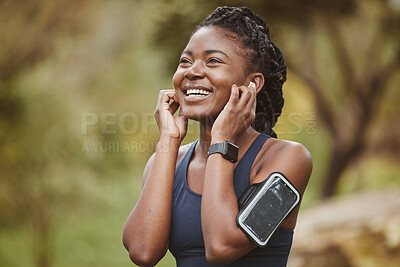 Buy stock photo Fitness, smile and black woman listening to music outdoor exercise, workout or training in a forest for wellness. Happy, confident and young person ready and enjoy radio, audio or podcast in nature