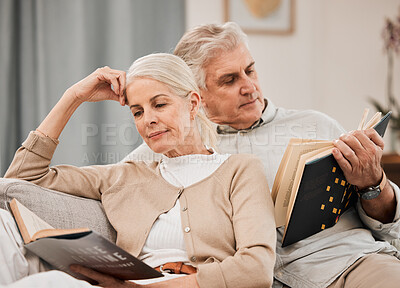 Buy stock photo Old couple, relax on sofa and reading book, retirement and support with time together at home. People in living room, knowledge and literature, leisure and hobby with love and comfort with story