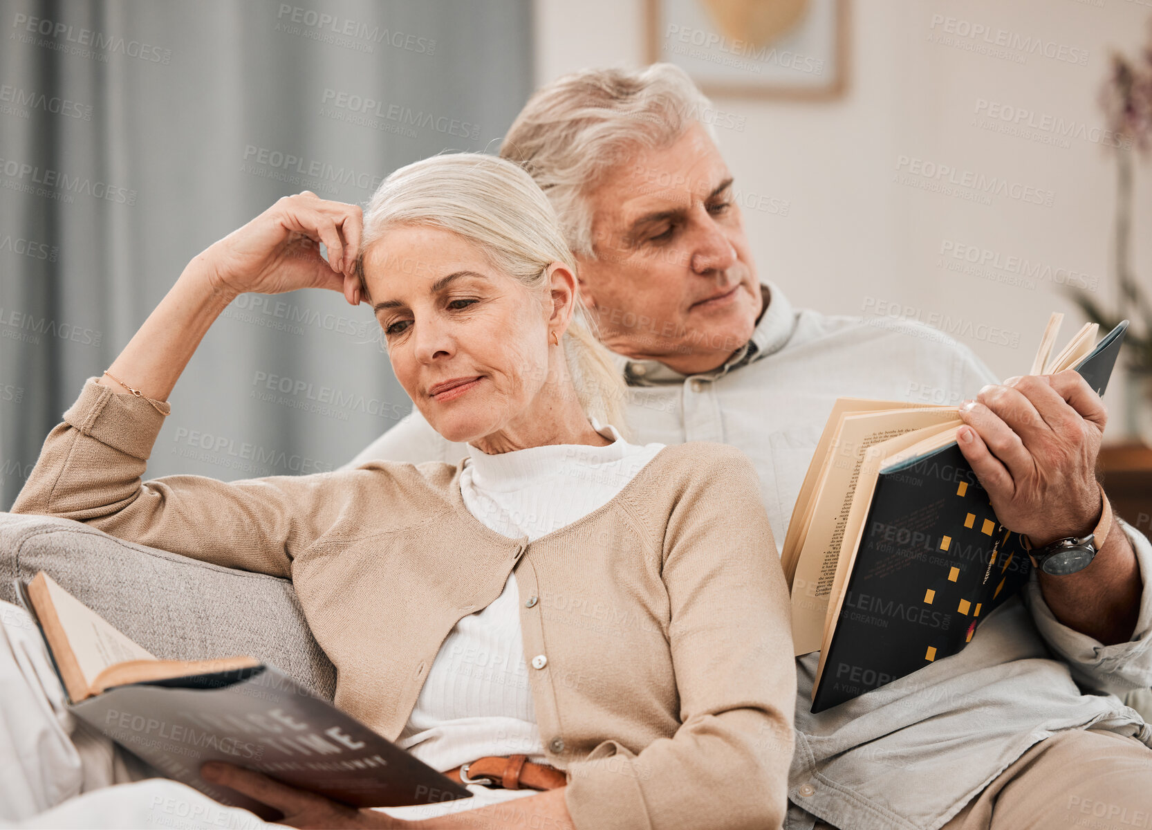 Buy stock photo Old couple, relax on sofa and reading book, retirement and support with time together at home. People in living room, knowledge and literature, leisure and hobby with love and comfort with story