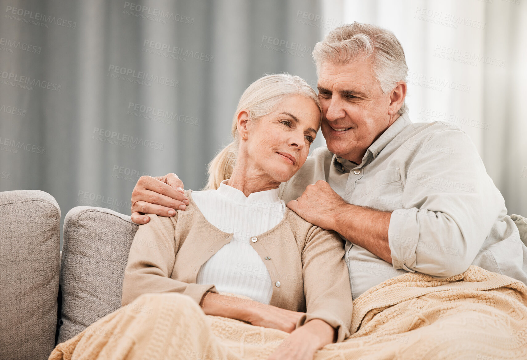 Buy stock photo Old couple, hug and relax on couch with love and support, bonding while at home with trust and comfort. People with time together, marriage or life partner with retirement, calm and peace of mind