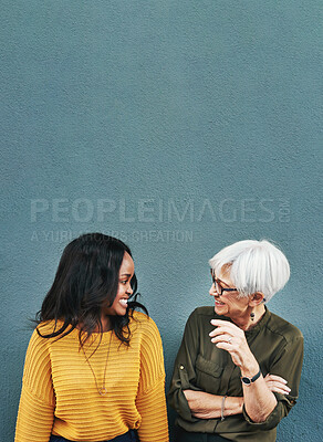 Buy stock photo Happy, conversation and women by a wall with mockup space for advertising, promotion or marketing. Smile, talking and female people in discussion together with comic or funny joke by gray background.