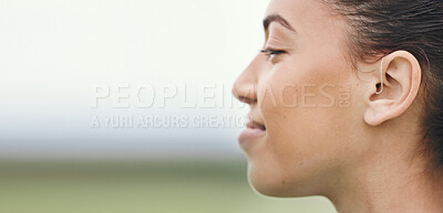 Buy stock photo Face, mockup or hearing aid and a sports woman outdoor with an implant for sound or audio improvement. Profile, deaf and happy young athlete with an ear disability or impairment at training on space