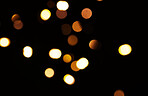 Gold, light and mockup with bokeh on dark background for New Year, Christmas or festive fireworks celebration at night. Mock up, space or sparkle in winter with magic, glow or shine on black backdrop
