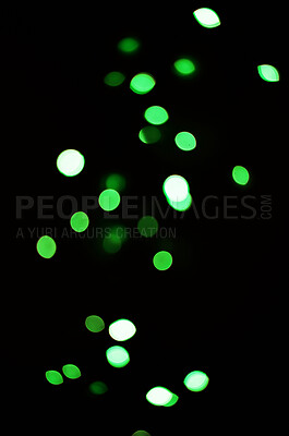 Buy stock photo Green light, bokeh and shine on black background isolated on a mockup space. Blur, dark backdrop and defocused glow, sparkle or glitter at night for Christmas, holiday or party with magic color dots