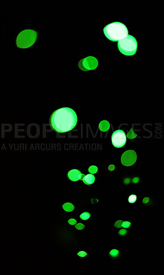 Buy stock photo Green, glitter and bokeh in a studio with dark background for celebration, event or party. Confetti, lights and color sparkles for magic, shine or glow for festive by black backdrop with mockup.