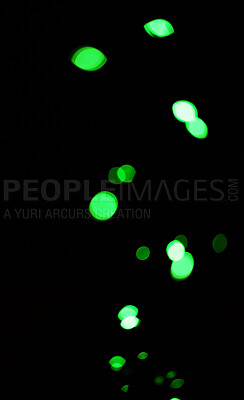 Bokeh, green dots and lights on black background with pattern, texture and mockup with cosmic aesthetic. Night lighting, sparkle particles and glow on dark wallpaper with space, color shine and flare