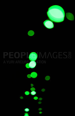 Bokeh, green particles and lights on black background with pattern, texture and mockup with cosmic aesthetic. Night lighting, sparkle dots and glow on dark wallpaper with space, color shine and flare