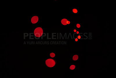 Bokeh, red particles and lights on black background with pattern, texture and mockup with cosmic aesthetic. Night lighting, sparkle dots and glow on dark wallpaper with space, color shine and flare.