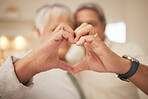 Heart hands, emoji and senior couple in home with commitment, support and marriage in retirement together. Love sign, happy man and old woman in apartment with icon for romantic gesture of loyalty.