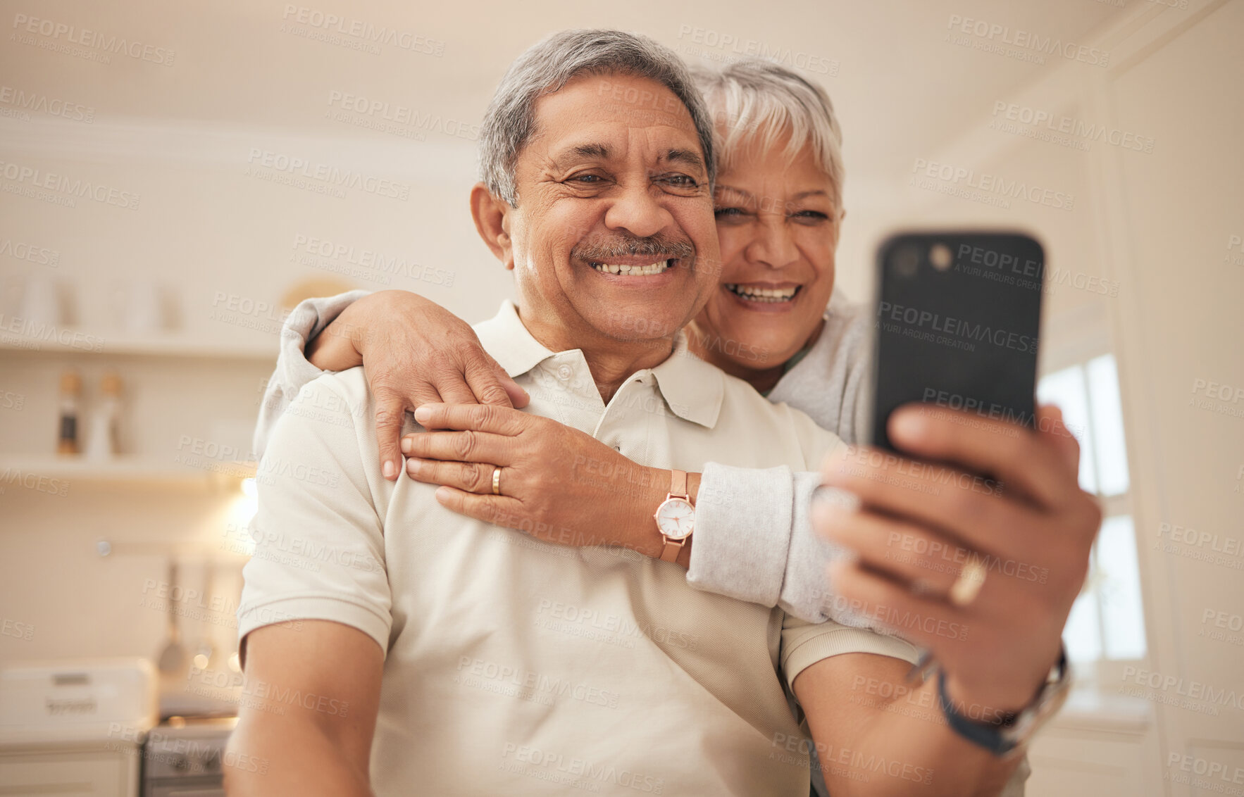 Buy stock photo Senior couple, home and smile with smartphone for video call, mobile streaming and scroll on social media in retirement. Happy old man, woman and hug with phone for selfie, reading news app and relax