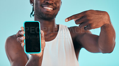 Buy stock photo Black man pointing at phone screen, technology with advertising mockup, mobile app and ads isolated on blue background. Information, sign up and website marketing with logo design and UX in a studio