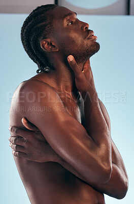 Buy stock photo Body, black man and shirtless profile in studio with art, skincare and glow from skin wellness and confidence. Muscle, hug and male model creative with blue background and self care with strong arms