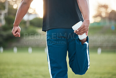 Buy stock photo Person, fitness and stretching leg on grass getting ready for sports training, workout or outdoor exercise. Rear view of sporty athlete in warm up for preparation, motivation or health and wellness