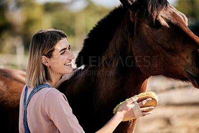 Horse, cleaning and woman with brush on ranch for animal care, farm pet and grooming in countryside. Farming, happy and person with stallion for brushing mane for wellness, healthy livestock and work