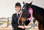 Portrait, equestrian and a woman winner with an animal on a ranch for sports, training or a leisure hobby. Smile, award or prize ribbon and a happy young rider in uniform with her stallion outdoor