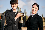 Portrait, girls and champion for equestrian, competition and horse riding with trophy at ranch. Young, women and celebration in happiness of achievement, sports and activity with prize in success