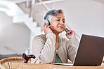 Laptop, music and a senior woman with a disability at the dining room table for streaming during retirement. Computer, headphones and walking stick with an elderly person in her house to relax