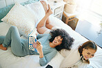 Smile, morning and a lesbian couple reading in bed while together in their home on the weekend. Diversity, lgbt love or relax with a happy gay woman and her girlfriend in the bedroom from above