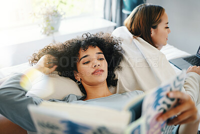 Buy stock photo Relax, morning and a lesbian couple reading in bed while together in their home on the weekend. Gay, book and an lgbt woman with her girlfriend in the bedroom for love, calm or bonding in pajamas