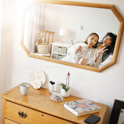 Buy stock photo Happy lesbian couple in bedroom with mirror, peace sign icon and relax together in apartment. Queer love, smile and reflection of lgbt women on bed with emoji hand gesture, trust and support in home.