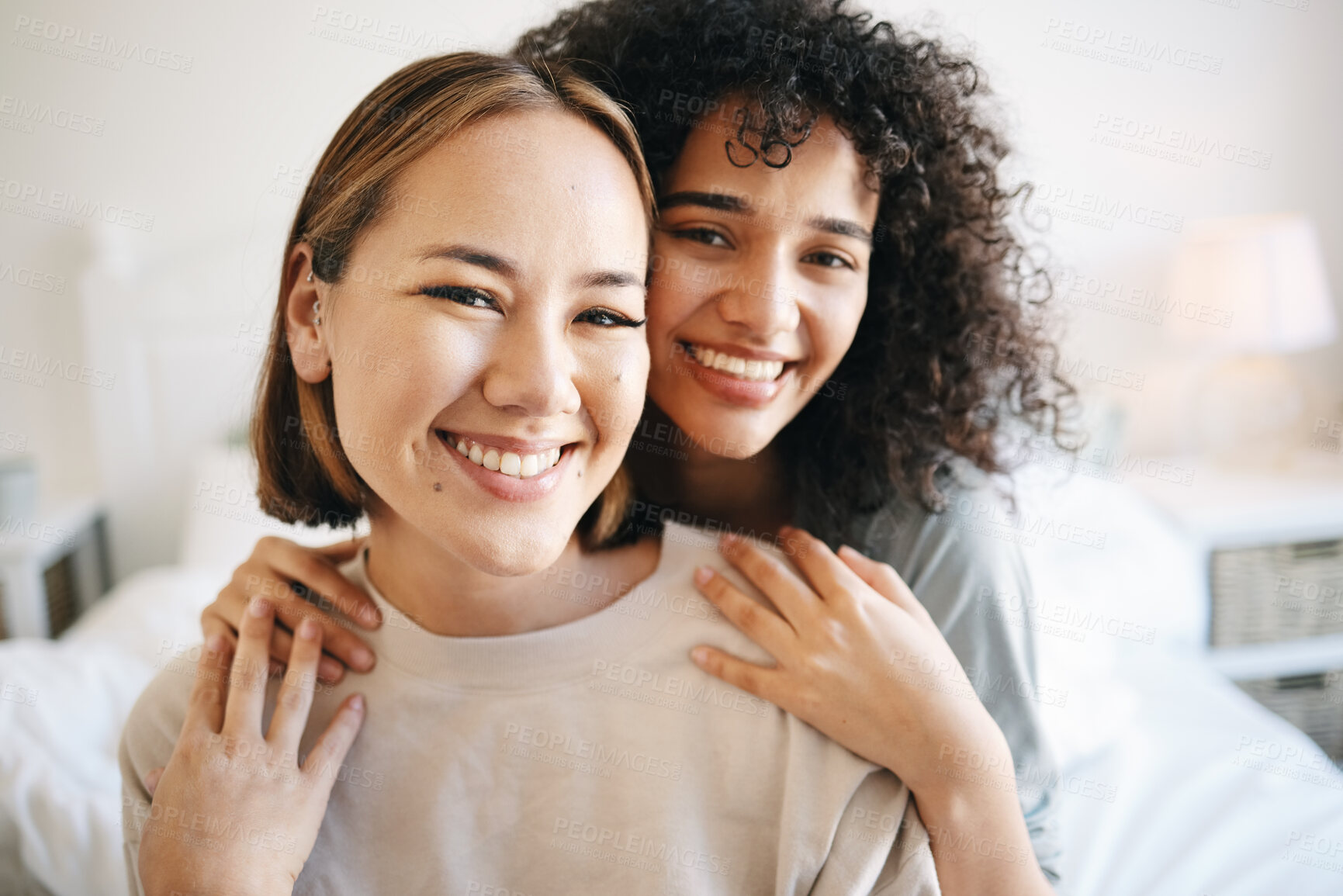 Buy stock photo Smile, happy and portrait of lesbian couple on bed for bonding, resting or relaxing together on weekend. Love, romance and young interracial lgbtq women in the bedroom of modern apartment or home.