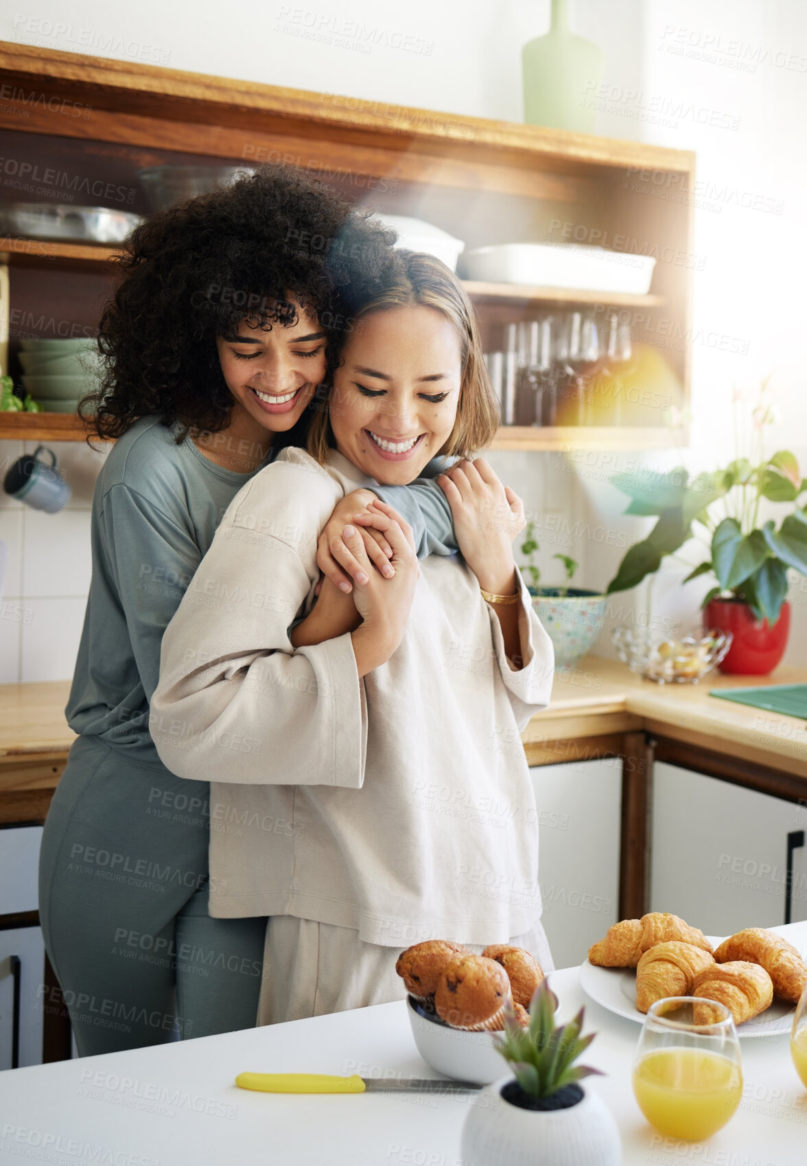 Buy stock photo Breakfast, lgbtq and couple hug in morning in home eating together for bonding, love and care. Embrace, lesbian and happy women with food for healthy relationship, nutrition and meal for romance