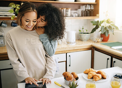Buy stock photo Lesbian, couple and kiss in kitchen with breakfast in morning together with nutrition, love and support in home. Lgbt, women or cooking with food, juice and preparing healthy diet on counter in house