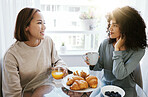 Orange juice, coffee and happy lesbian couple in home at table bonding together. Drink, food and croissant of gay women in the morning for breakfast diet, eating and healthy interracial relationship
