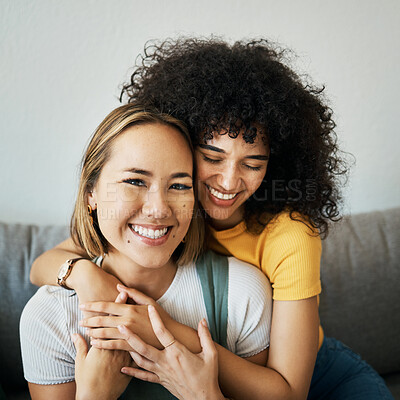 Buy stock photo Lesbian, couple and portrait of hug on sofa in home, living room or apartment with love, support and happiness. Lgbt, women and relax together with pride, confidence and smile on face in house