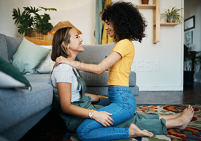 Buy stock photo Lesbian, couple and women relax together on floor at home, bonding with love and pride, happiness and care. Support, trust and healthy relationship, LGBTQ with smile and romance in living room