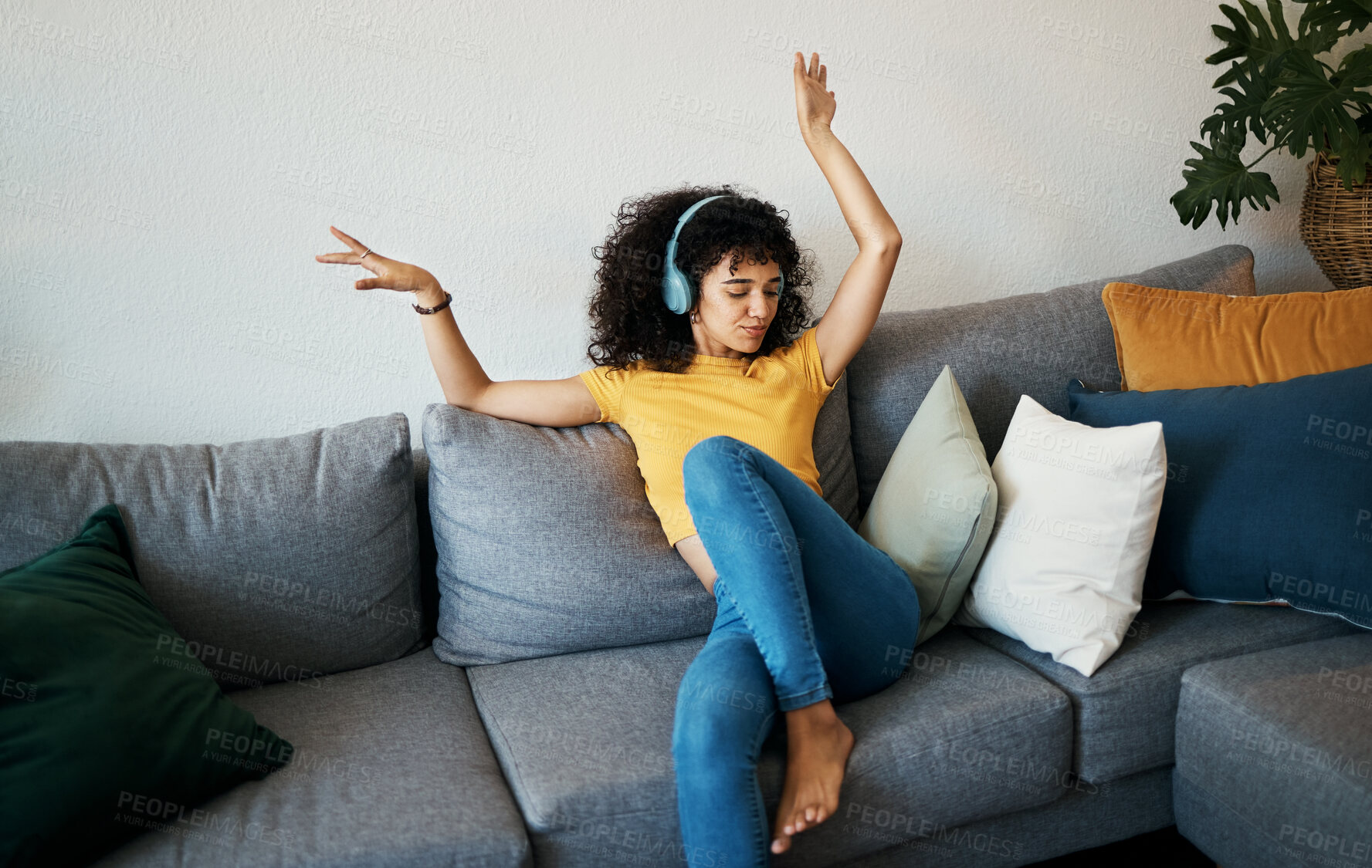 Buy stock photo Music, headphones and woman dance on a sofa with podcast, album or audio track at home. Radio, earphones and female person having fun in living room with feel good subscription, streaming or freedom