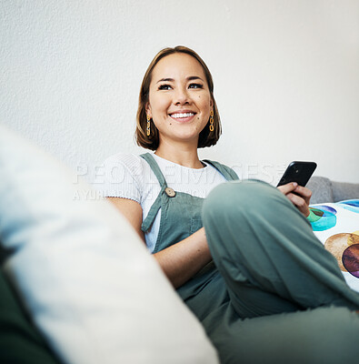 Buy stock photo Woman, phone and thinking on couch of home for social media, internet post or conversation with smile. Person, smartphone and happiness for communication, networking and connectivity with technology