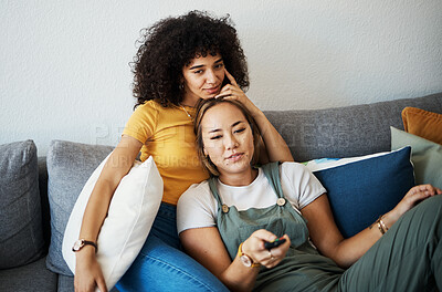 Buy stock photo Love, relax and a gay couple watching tv on a sofa in the living room of their home together. Television, LGBT and a woman with her lesbian girlfriend for movie on a subscription streaming service
