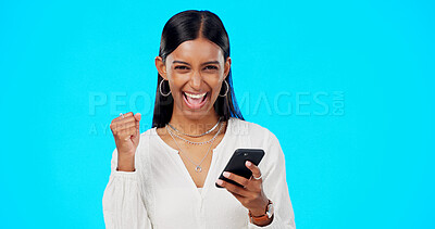 Buy stock photo Winner woman, phone and studio with fist celebration, portrait and excited for prize by blue background. Girl, trader and smartphone with cheers, success or goals with investment, fintech or stocks