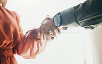 Buy stock photo Creative people, handshake and partnership in meeting, b2b deal or teamwork below at office. Low angle of man and woman shaking hands for startup, introduction or thank you in agreement at workplace