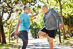 Senior man, friends and stretching in park for running, exercise or outdoor training together in nature. Mature people in body warm up, leg stretch or preparation for cardio workout or team fitness