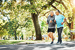 Senior, men and running for fitness in road of city for wellness, exercise or workout outdoor with smile. Elderly, people and training together in nature or park for health, adventure and happiness