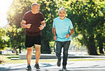 Elderly, men and running for fitness in road of city for wellness, exercise or workout outdoor with smile. Senior, people and training together in nature or park for health, adventure and happiness