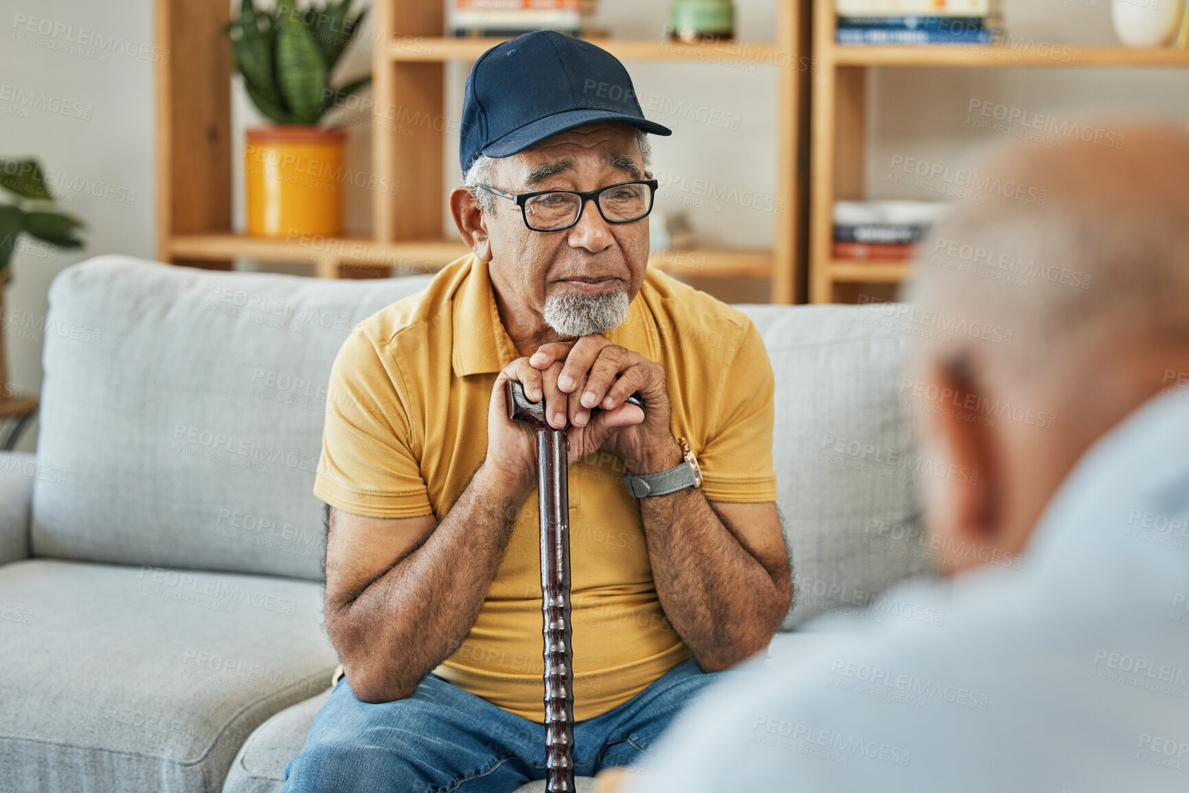 Buy stock photo Doctor, consultation and senior man on sofa with walking stick or counselling discussion in therapy with psychologist. Elderly patent, talking and therapist listening on couch in mental health office